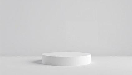 A cylindrical platform stands empty on a white backdrop, symbolizing a place for an object of admiration.
