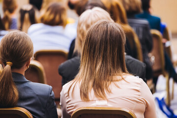 Female audience at the symposyum meeting, participants attendees in conference room hall listens to...