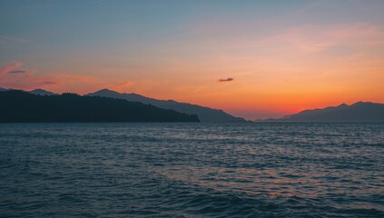 Beautiful ocean and mountain landscape after sunset