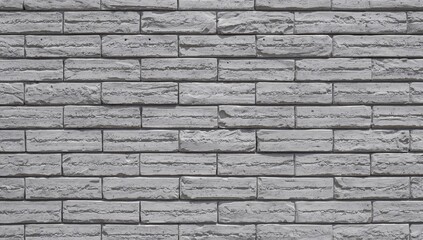 Obraz premium Gray bricks forming a wall with alternating horizontal placement, showcasing a mix of shadows and hues.