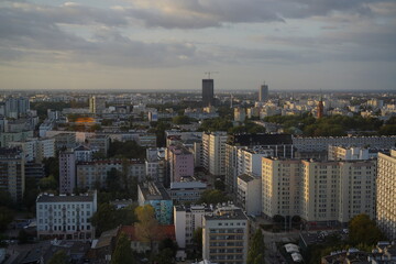 Fototapeta premium Overview of a modern city skyline during sunset with clouds in the sky