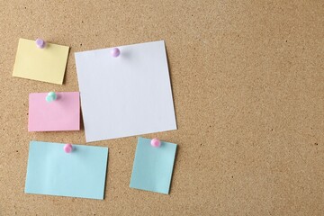 Blank colorful notes pinned on cork board, space for text
