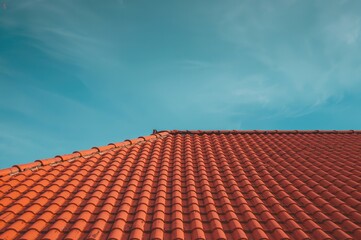 Overhead perspective of a vintage roof with orange tiles showing texture and pattern