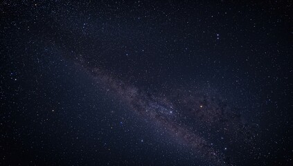 Fototapeta premium Twinkling stars across the galaxy's dark expanse