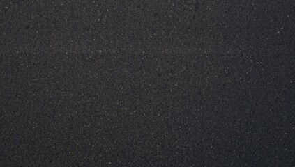 Obraz premium Close-up aerial perspective of freshly laid black tarmac road surface