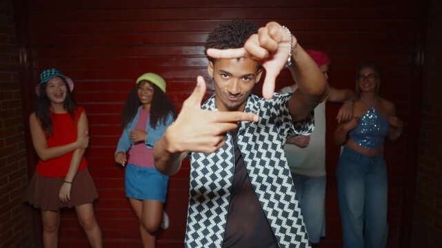 Diverse group of young stylish friends  laughing, and dancing together during a party, enjoying the music and celebrating friendship in a lively nighttime atmosphere