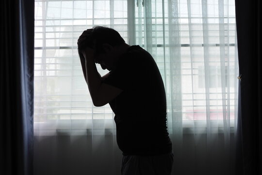 Silhouette of a business man in front of the window In various postures