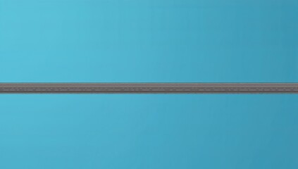 Isolated stretch of pavement against a clear blue sky