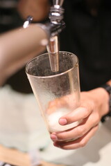 Pouring refreshing beverage into a tall glass