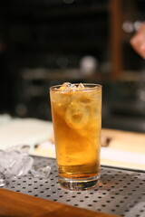 A refreshing drink with ice in a highball glass on a bar, perfect for a relaxing evening