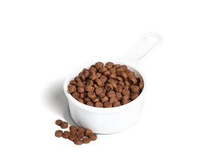 Insect protein kibble for cats or dogs in measuring cup. BSFL or Black Soldier Fly Larvae dry food recipe for pets with food allergies or sensitivities. Sustainable single protein. Selective focus.