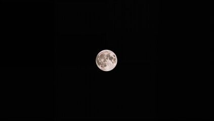 Close-up view of the glowing moon against a pitch-black sky, captured with an ultra-telephoto lens from the ground.