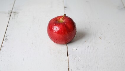 Moist crimson apple resting on a surface