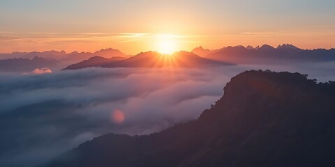 Fototapeta premium The image displays a scenic view of a sunrise over foggy mountains.