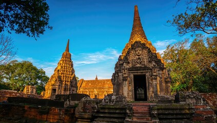 Fototapeta premium Ancient temple towers surrounded by trees in a tropical park