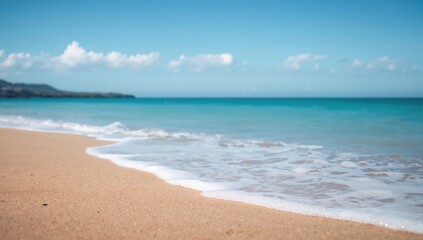Fototapeta premium A simple scene of soft waves touching the sandy beach, showcasing nature and the sea's calm beauty