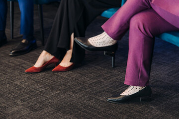 Speakers shoes legs at the business conference event, audience on forum summit, plenary session...