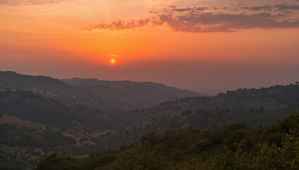 Fototapeta premium Twilight casting a warm glow on a mountainous valley