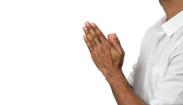 Interlocked hands, praying or greeting, right of frame, against a solid dark backdrop. White shirt, side face visible