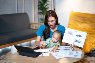 Stressed mother working from home with baby