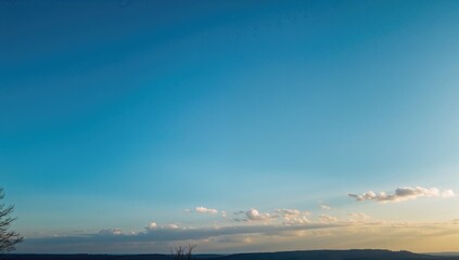 Scattered charming clouds spread across a clear blue sky