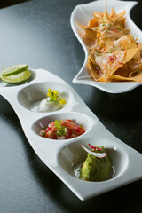Elegant plating of nachos and appetizers, featuring vibrant colors and textures