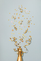 Party, New Year or birthday festive background with golden champagne bottle and confetti stars....