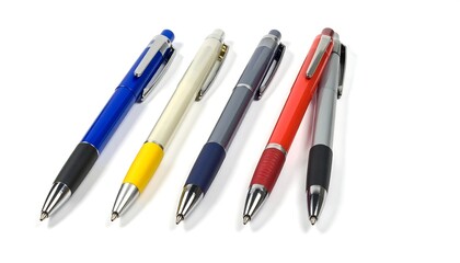 Fototapeta premium Five multicolored ballpoint pens laid at an angle against a plain white background