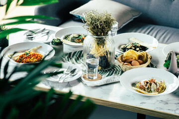 A gourmet meal of several dishes served on a table