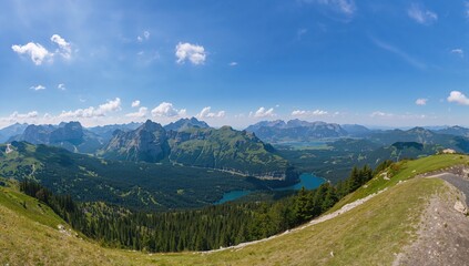 Obraz premium Panoramic view of a mountain range in summer