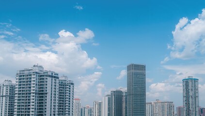 Obraz premium Tall residential buildings standing alone under a clear blue sky in an urban area with room for text