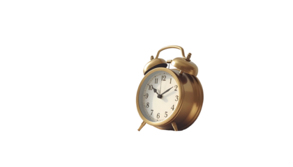 Gold-toned analog alarm clock with bells isolated on black. Shows roughly 1052