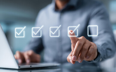 Focused businessman completes task on digital checklist interface. concept of evaluation, quality control, and business technology for project management and success