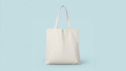 White cotton canvas tote bag mockup for eco-friendly shopping, isolated on a soft blue background (clipping path)
