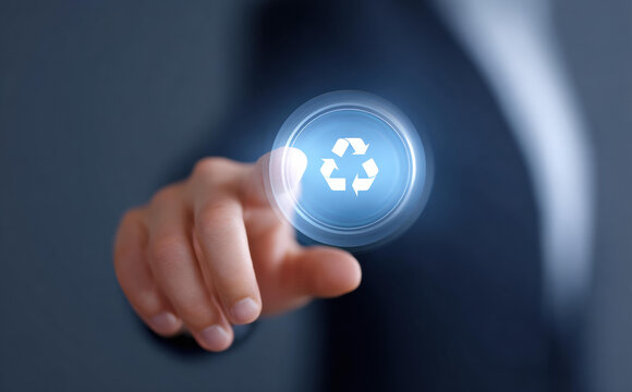 Focused businessman pointing finger at glowing blue recycle button. Concept for sustainability, environment, technology, business and corporate responsibility