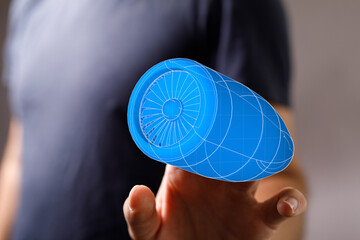 Innovative engineering concept featuring a 3D blueprint of an airplane part held on a finger, symbolizing technology, aviation, and design.