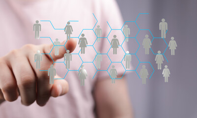 Abstract design of a hand touching a network diagram with people silhouettes, representing...
