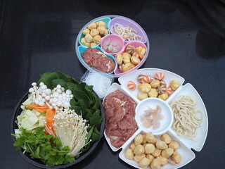 Fresh organic vegetables with various types of meatballs, thin slices of pork, vermicelli. Set for thai style grilled pork, MooKata, Sukiyaki. Dip meat and vegetables in boiling water, grill  on stove