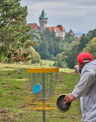 Disc Golf and man final shot with castle