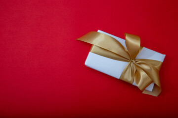 Gift boxes with satin ribbons on red background. Concept of celebration, sale or romantic event.
