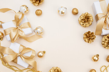 Christmas and New Year background with gift boxes, golden ribbons and decorations. Minimal festive composition with copy space for text or design.