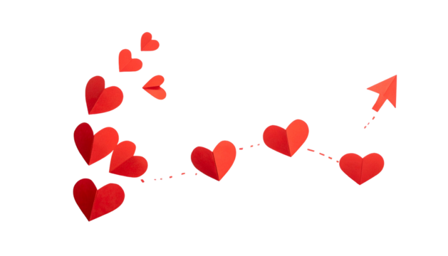 Red paper hearts arranged in a curving arrow shape with a black background