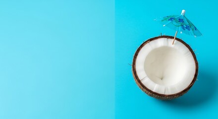 Tropical beach concept made of coconut fruit and sun umbrella. Creative minimal summer idea.