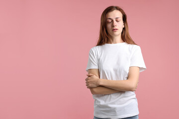 Fototapeta premium Woman crying on pink background. Space for text