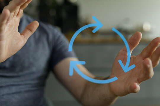 Image of a person interacting with an animated loop of arrows, representing concepts like renewal and repetition in business or technology.