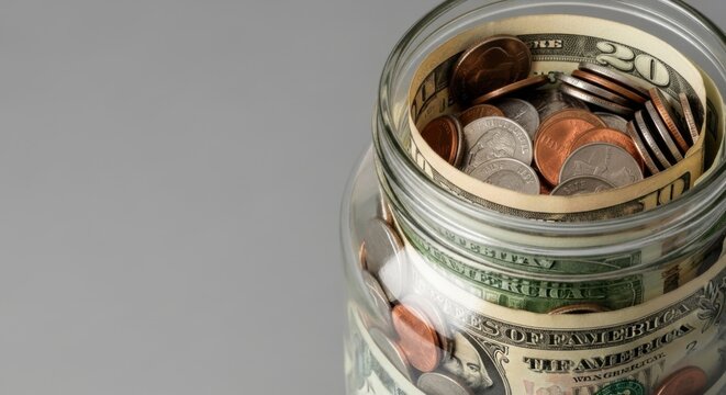 Day of goodwill celebration with a jar of coins and cash for charity contributions and savings concepts