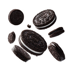Floating oreo cookies with crumbs on a black background in a studio shot with bright lighting setup
