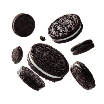 Floating oreo cookies with crumbs on a black background in a studio shot with bright lighting setup