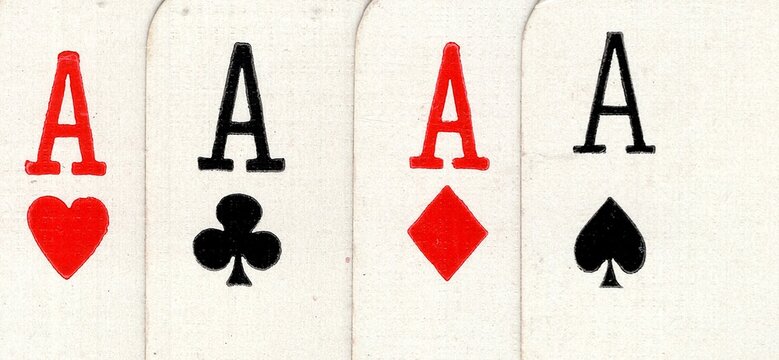 Close up detail of four playing cards of the same value.