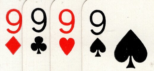 Close up detail of four playing cards of the same value.